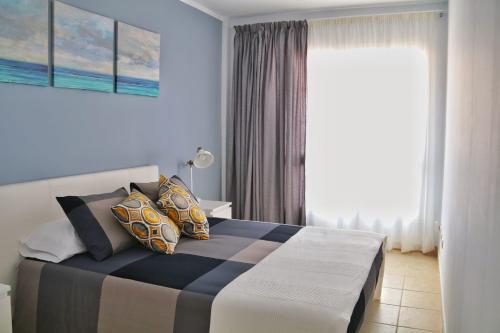 a bedroom with a bed and a window at Home Sweet Home with Ocean View in Costa Calma