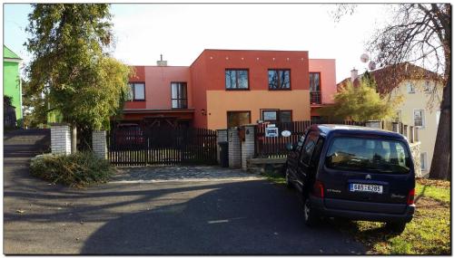 a small car parked in front of a house at Apartments České Středohoří in Teplice