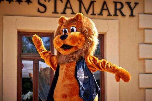 a mascot standing in front of a building at Grand Hotel Stamary in Zakopane
