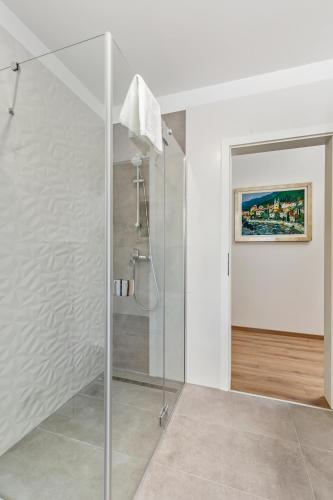 a bathroom with a shower with a glass door at Apartment Niki in Opatija