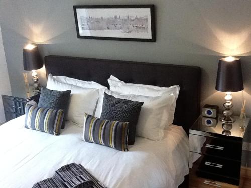 a bedroom with a white bed with pillows at Flat 4 Summertown Court in Oxford