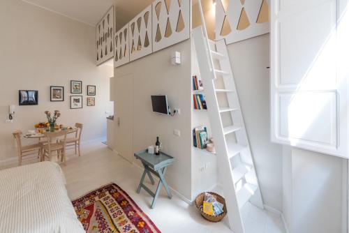 a small apartment with a staircase and a living room at casa minù lamarmora in Cagliari