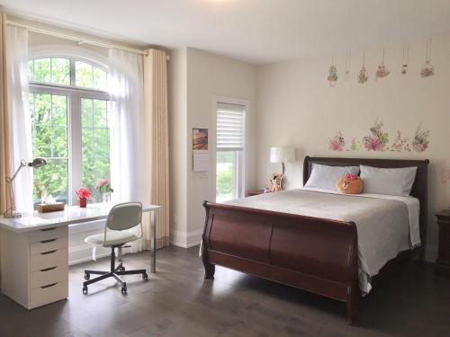 a bedroom with a bed and a desk and a chair at Comfortable private space in Pickering