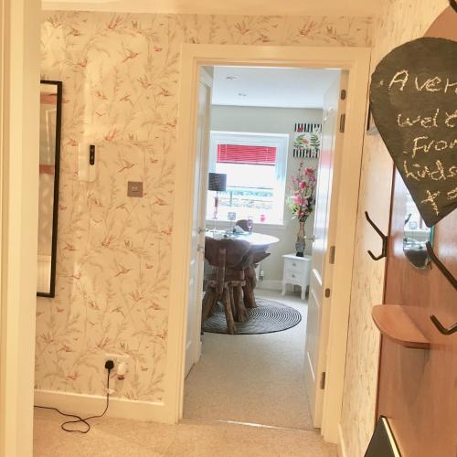 a hallway leading to a bathroom with a sink at The Little Beech Tree in Linlithgow