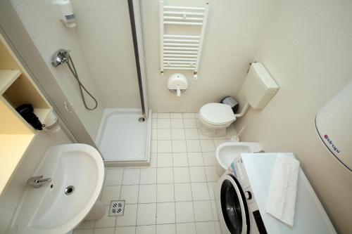 a bathroom with a sink and a toilet and a shower at Apartment Brownie in Timişoara