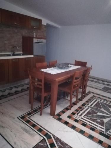 a kitchen with a wooden table and chairs at B&B Le Rocce in Castel San Giorgio