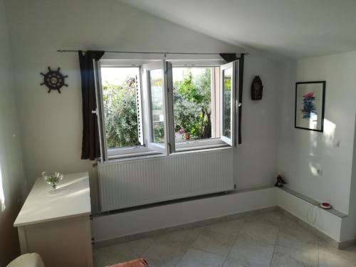 a bathroom with a sink and two windows at Olive grove in Vodice