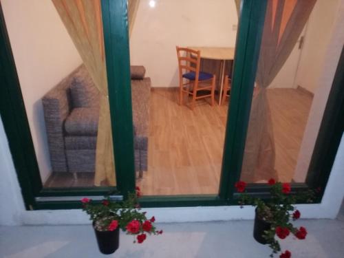 a view of a living room from a window at Apartman Milica in Golubić