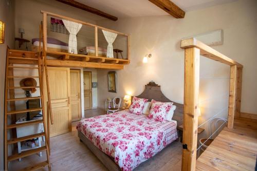 a bedroom with a bed and a bunk bed at Les Chambres d'hotes de Laurette in Bertrambois