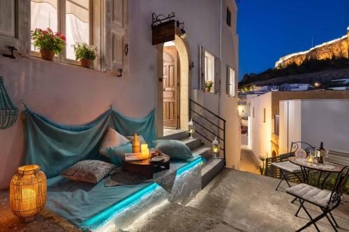 a balcony with a bed on the side of a building at Casa Pietra Lindos Luxury Traditional House in Lindos