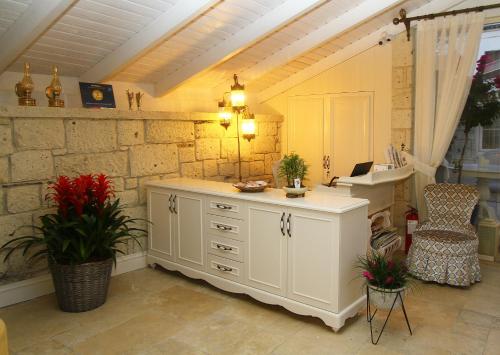 a kitchen with a white cabinet and a sink at Salbakos Herakleia Hotel in Alacati