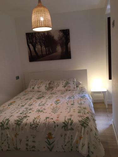 une chambre avec un lit avec une couette dessus dans l'établissement Vicaria, à Gijón