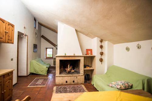 a living room with a fireplace in a house at Attico vintage Roccaraso in Roccaraso