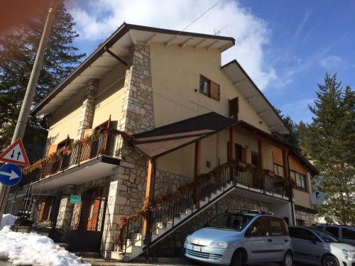 a building with cars parked in front of it at Attico vintage Roccaraso in Roccaraso