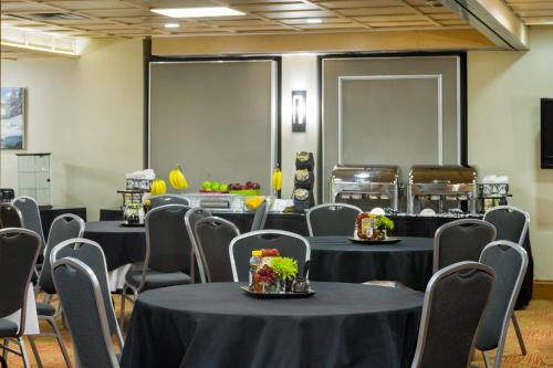 a room with black tables and chairs with flowers on them at Vail's Mountain Haus at the Covered Bridge in Vail