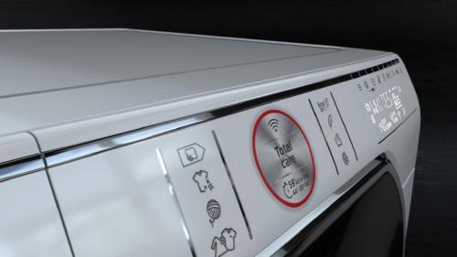 a close up of a white washing machine with stickers on it at Walters Hostel Interlaken in Interlaken