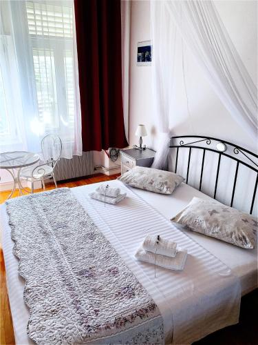 a bedroom with a large white bed with two towels at Apartment Riva in Makarska