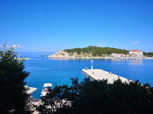a view of a large body of water with a dock at Apartment Riva in Makarska