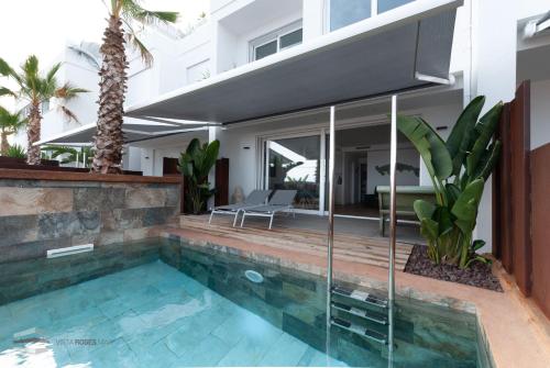 a swimming pool in the backyard of a house at Vista Roses Mar - Ancla Mar in Roses