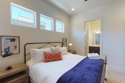 a bedroom with a large white bed and two windows at Villa #8 in St. George