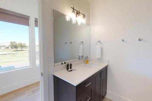 a bathroom with a sink and a large mirror at Villa #8 in St. George