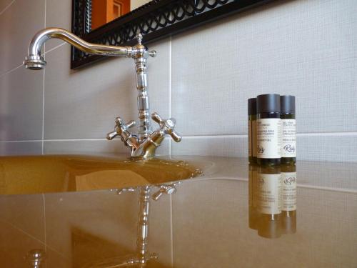 a bottle of soap sitting on top of a bathroom sink at Refugio da Ti Maria in Batalha