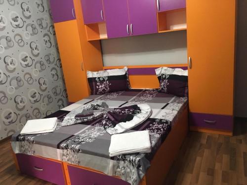 a bedroom with a bed with colorful walls at Casa Stefania in Eforie Nord