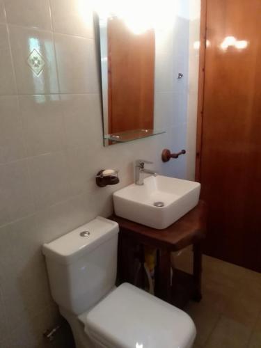 a bathroom with a white toilet and a sink at Garden Bungalow Valentina in Stavros