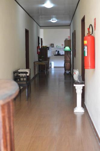 a living room with a hard wood floor and a red fire hydrant at Pousada Colibri in Trindade