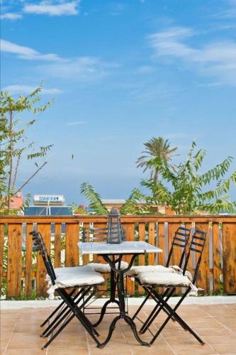 two chairs and a table on a patio with a table and chairs at Kristina´s rooms in Rhodes Town