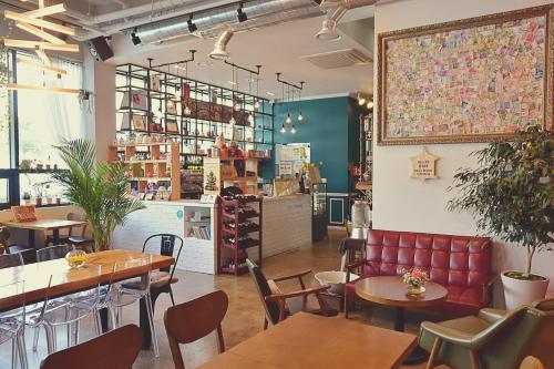 a restaurant with tables and chairs and a counter at Andong Poong-gyung HOSTEL n LIBRARY in Andong