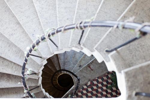 a view of a spiral stairway with a checkerboard at Economy Hotel in Tallinn