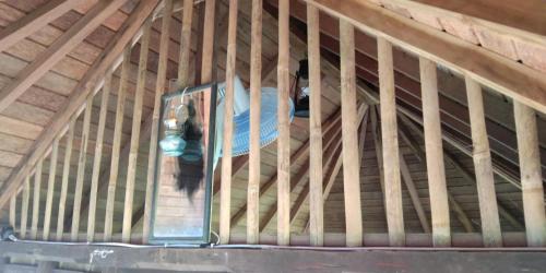 a person is standing in a wooden cage at ESA di Kubu Homestay in Singaraja