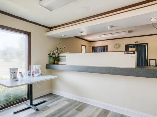 a room with a white counter and a table at Raceway Inn Darlington By OYO in Darlington