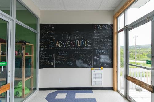 a classroom with a chalkboard on the wall at Out East Hostels - Rocky Harbour in Rocky Harbour