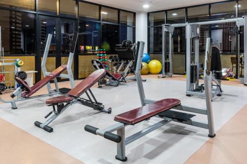 a gym with several treadmills and exercise bikes at Boulevard Residencial in Salvador