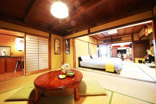 a bedroom with a bed and a table in it at Nara Imai House in Nara