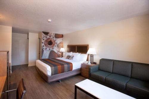 a hotel room with a bed and a couch at Best Western Sandman Hotel in Sacramento