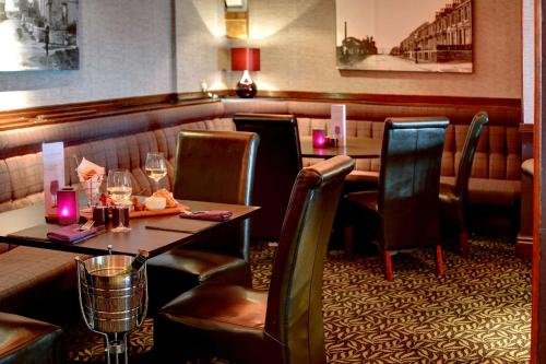 a dining room with a table and chairs in a restaurant at Higher Trapp Hotel in Padiham