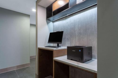 a computer sitting on a desk with a monitor at La Quinta by Wyndham Ft. Myers - Sanibel Gateway in Fort Myers