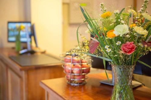 a vase filled with flowers on top of a table at Best Western Gables Hotel in Falfield