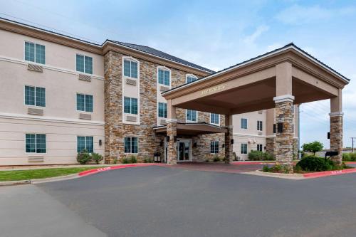 a large building with a parking lot in front of it at Comfort Inn & Suites, Odessa I-20 in Odessa