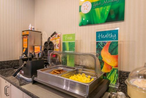 a kitchen counter with a buffet of food at Quality Inn Bend North in Bend