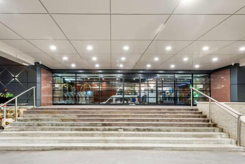 a building with stairs in front of a building at Quality Hotel Dorval Aeroport in Dorval