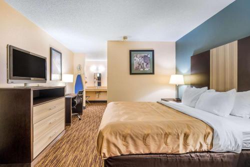 a hotel room with a bed and a flat screen tv at Quality Inn Cullman I-65 exit 310 in Cullman
