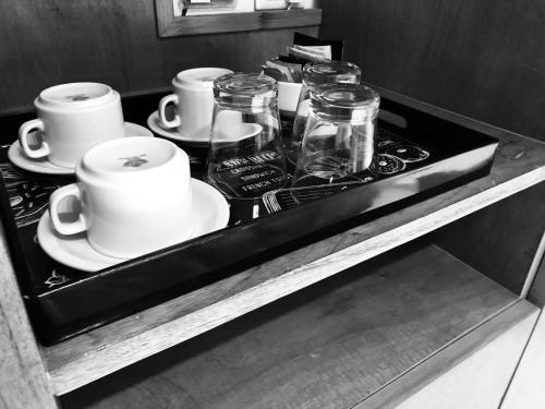 a shelf with cups and jars on a stove at Alberta B&B in La Rioja