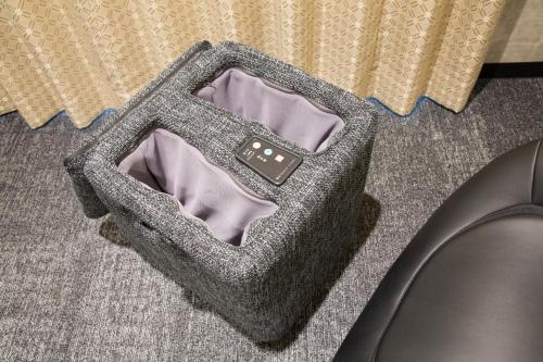 a bag sitting on the floor next to a chair at Shizutetsu Hotel Prezio Kyoto Karasumaoike in Kyoto
