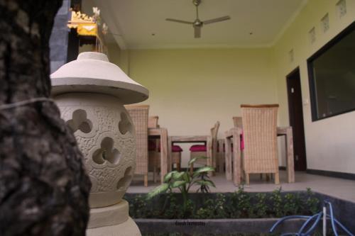 a view of a living room with a table and chairs at Dayuh Homestay in Amed