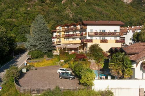 a building with a car parked in a parking lot at Hotel Rotwand in Laives