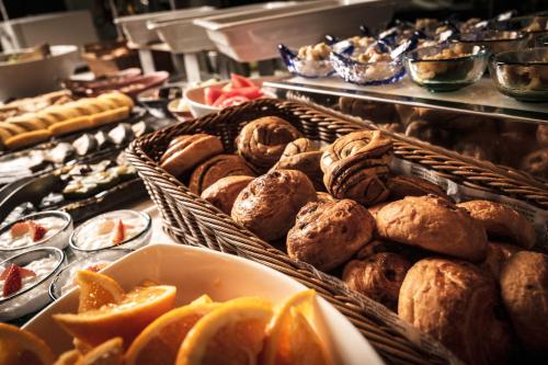 a buffet with baskets of different types of pastries at Hotel Kuu Kyoto in Kyoto